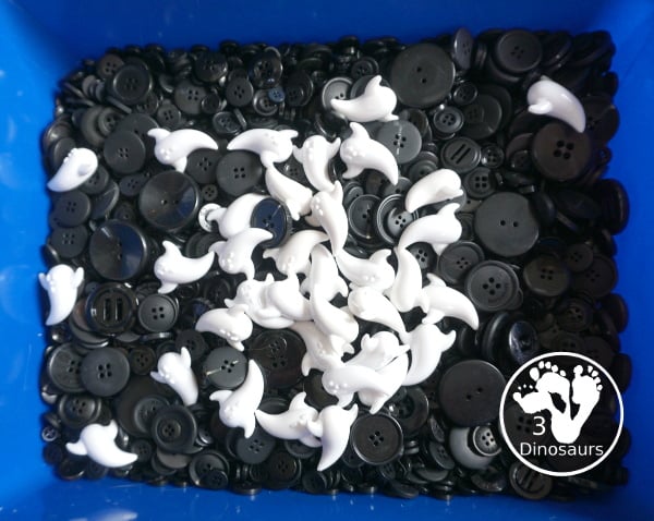 Ghost Button Sensory Bin - a simple sensory bin with ghost and black buttons for the filler. A fun Halloween sensory bin for kids. - 3Dinosaurs.com