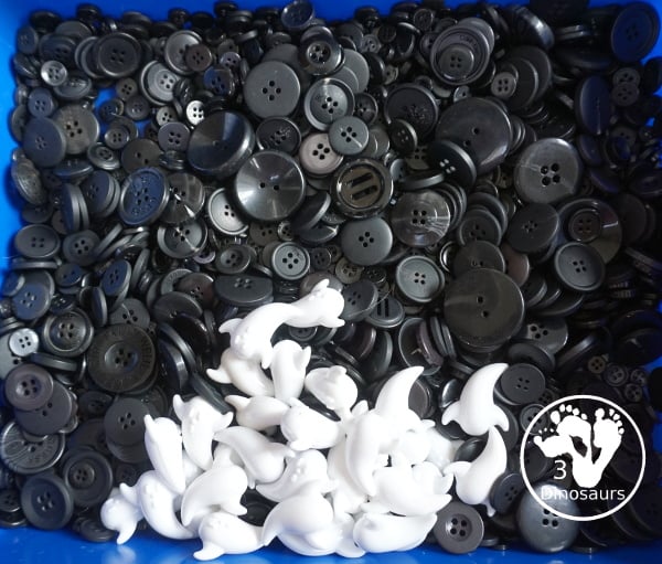 Ghost Button Sensory Bin - a simple sensory bin with ghost and black buttons for the filler. A fun Halloween sensory bin for kids. - 3Dinosaurs.com