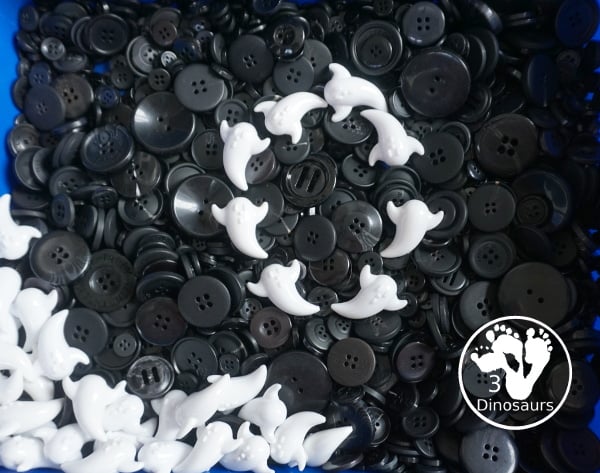 Ghost Button Sensory Bin - a simple sensory bin with ghost and black buttons for the filler. A fun Halloween sensory bin for kids. - 3Dinosaurs.com