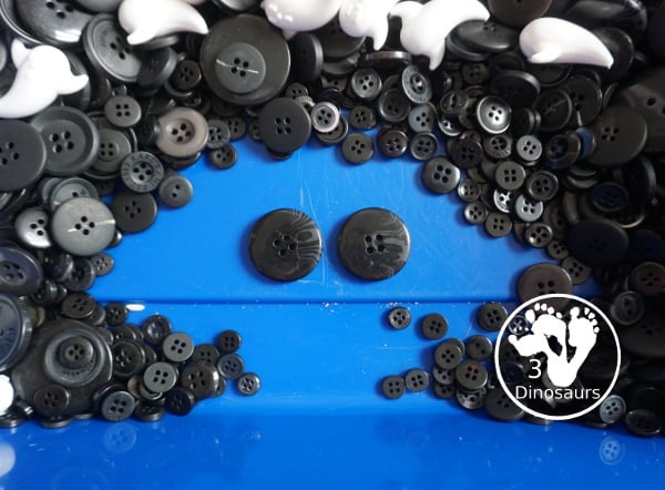 Ghost Button Sensory Bin - a simple sensory bin with ghost and black buttons for the filler. A fun Halloween sensory bin for kids. - 3Dinosaurs.com