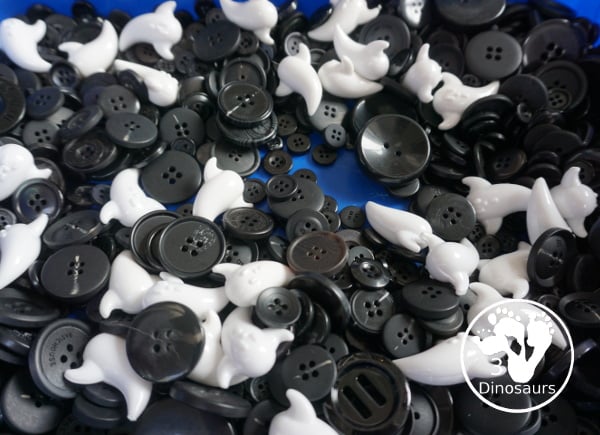 Ghost Button Sensory Bin - a simple sensory bin with ghost and black buttons for the filler. A fun Halloween sensory bin for kids. - 3Dinosaurs.com