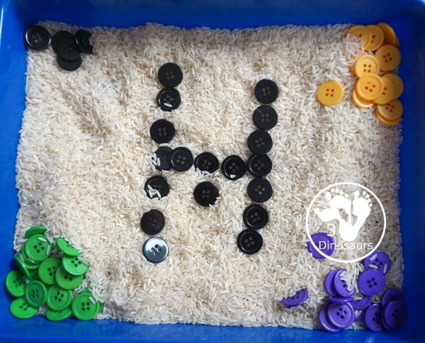 Halloween Button Black, Orange, Green & Purple Sensory Bin - is a simple button sensory bin with Halloween colors for black, orange, purple and green. They are in a rice filled for the base - 3Dinosaurs.com