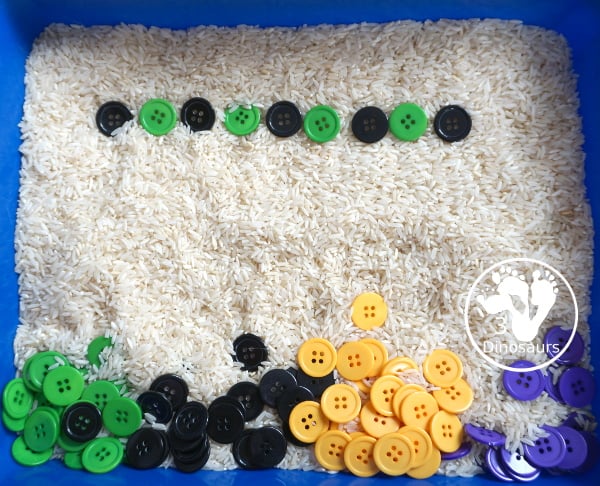 Halloween Button Black, Orange, Green & Purple Sensory Bin - is a simple button sensory bin with Halloween colors for black, orange, purple and green. They are in a rice filled for the base - 3Dinosaurs.com