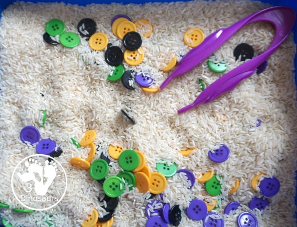 Halloween Button Black, Orange, Green & Purple Sensory Bin - is a simple button sensory bin with Halloween colors for black, orange, purple and green. They are in a rice filled for the base - 3Dinosaurs.com