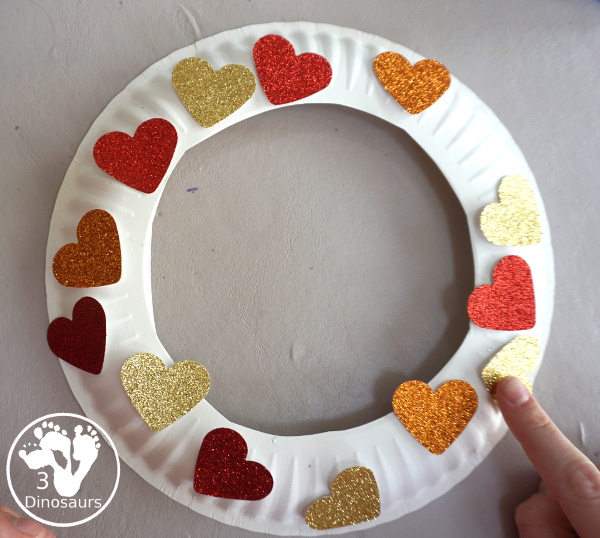 Rainbow Heart Wreath - made with glitter hearts and a paper plate that is super simple to put together for heart theme of Valentines - 3Dinosaurs.com