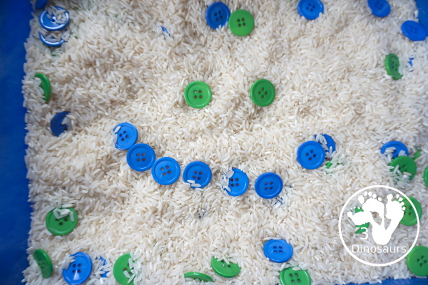 Blue & Green Button Sensory Bin for Earth Day -  you have a simple sensory bin with a rice filler with blue and green sensory bins.  - 3Dinosaurs.com