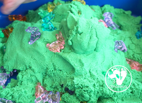 Bunny and Kinetic Sand Sensory Bin - a fun sensory bin for Easter with fun colors of bunnies in green kinetic sand. An easy to se up sensory bin for Easter and spring. - 3Dinosaurs.com