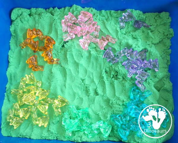 Bunny and Kinetic Sand Sensory Bin - a fun sensory bin for Easter with fun colors of bunnies in green kinetic sand. An easy to se up sensory bin for Easter and spring. - 3Dinosaurs.com
