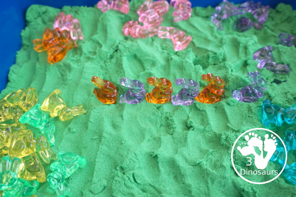 Bunny and Kinetic Sand Sensory Bin - a fun sensory bin for Easter with fun colors of bunnies in green kinetic sand. An easy to se up sensory bin for Easter and spring. - 3Dinosaurs.com