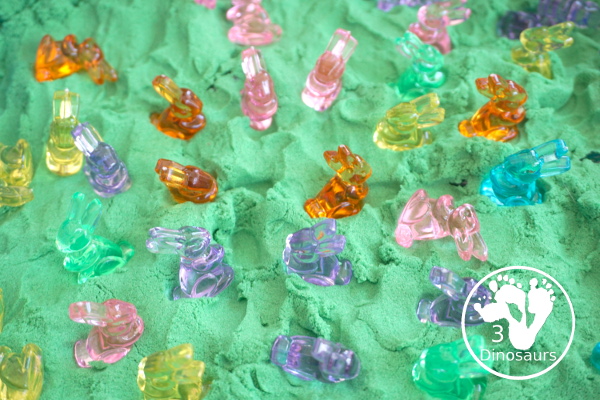 Bunny and Kinetic Sand Sensory Bin - a fun sensory bin for Easter with fun colors of bunnies in green kinetic sand. An easy to se up sensory bin for Easter and spring. - 3Dinosaurs.com