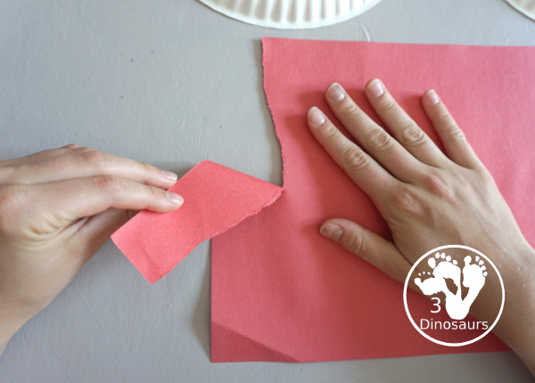 Red, White, & Blue Torn Paper Wreath is a fun wreath you can make with kids. You use torn paper of red, white, and blue glued on the wreath. A simple idea for the Fourth of July for kids. 3Dinosaurs.com