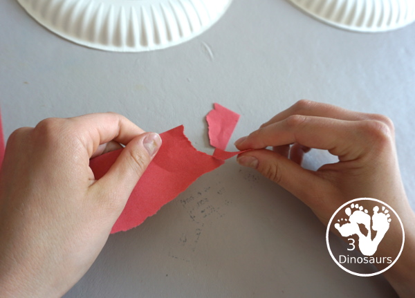 Red, White, & Blue Torn Paper Wreath is a fun wreath you can make with kids. You use torn paper of red, white, and blue glued on the wreath. A simple idea for the Fourth of July for kids. 3Dinosaurs.com