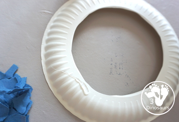 Red, White, & Blue Torn Paper Wreath is a fun wreath you can make with kids. You use torn paper of red, white, and blue glued on the wreath. A simple idea for the Fourth of July for kids. 3Dinosaurs.com