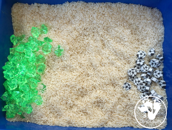 Soccer Sensory Bin - a simple sensory bin with rice filler with green rocks and soccer erasers for the parts of the sensory bin. A fun summer sport theme for kids. 3Dinosaurs.com