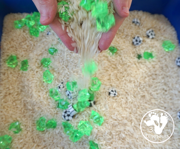 Soccer Sensory Bin - a simple sensory bin with rice filler with green rocks and soccer erasers for the parts of the sensory bin. A fun summer sport theme for kids. 3Dinosaurs.com