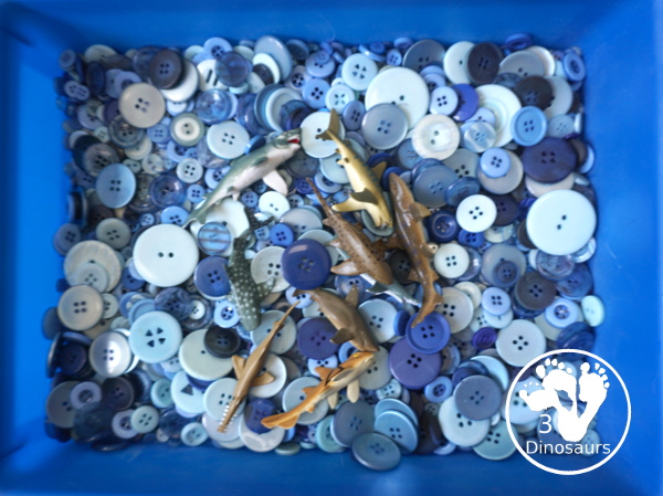 Shark Button Sensory Bin -a simple button sensory bin filler with different types of sharks in the sensory bin. A fun sensory play for shark week or any shark theme that you might be doing. - 3Dinosaurs.com