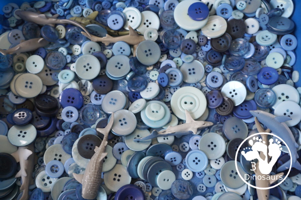 Shark Button Sensory Bin -a simple button sensory bin filler with different types of sharks in the sensory bin. A fun sensory play for shark week or any shark theme that you might be doing. - 3Dinosaurs.com