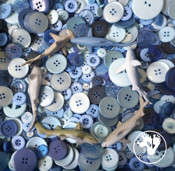 Shark Button Sensory Bin -a simple button sensory bin filler with different types of sharks in the sensory bin. A fun sensory play for shark week or any shark theme that you might be doing. - 3Dinosaurs.com