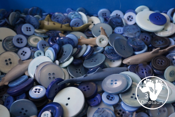 Shark Button Sensory Bin -a simple button sensory bin filler with different types of sharks in the sensory bin. A fun sensory play for shark week or any shark theme that you might be doing. - 3Dinosaurs.com