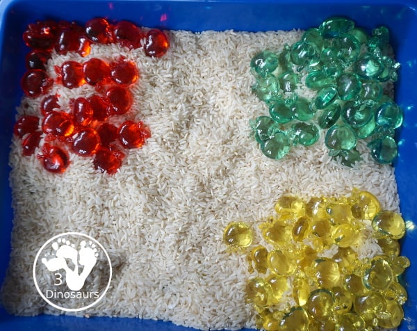 Simple Apple Sensory Bin - with acrylic apples and rice sensory bin. You have red apples, yellow apples, and green apples. This is a great sensory bin for the fall, and back to school. You can use it for any apple theme.  3Dinosaurs.com