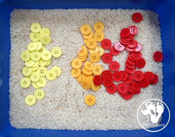 Fall Button Sensory Bin: Red, Yellow & Orange - a simple fall sensory bin with red buttons, yellow buttons and orange buttons with a rice filler. A fun and easy to set up fall sensory bin - 3Dinosaurs.com