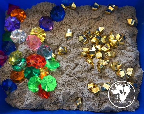 Pirate Treasure Kinetic Sensory Bin - a fun sensory bin for a pirate theme or talk like a pirate day. A fun way to dig and search and find treasure in the bin with gems, gold and kinetic sand. 3Dinosaurs.com