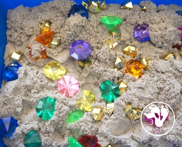 Pirate Treasure Kinetic Sensory Bin - a fun sensory bin for a pirate theme or talk like a pirate day. A fun way to dig and search and find treasure in the bin with gems, gold and kinetic sand. 3Dinosaurs.com