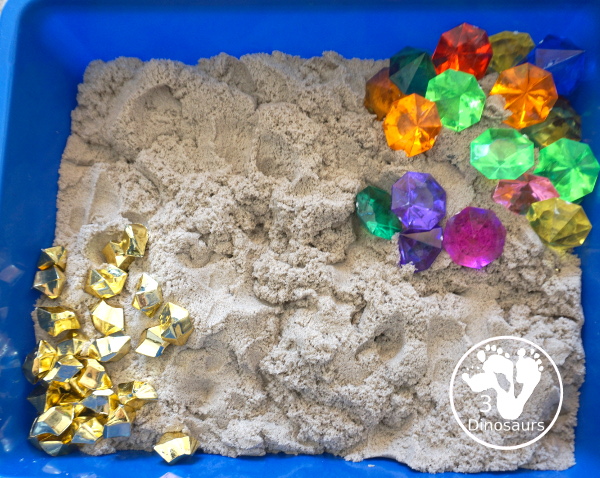 Pirate Treasure Kinetic Sensory Bin - a fun sensory bin for a pirate theme or talk like a pirate day. A fun way to dig and search and find treasure in the bin with gems, gold and kinetic sand. 3Dinosaurs.com