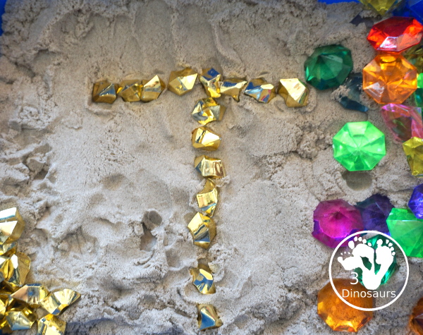 Pirate Treasure Kinetic Sensory Bin - a fun sensory bin for a pirate theme or talk like a pirate day. A fun way to dig and search and find treasure in the bin with gems, gold and kinetic sand. 3Dinosaurs.com