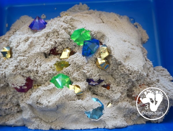 Pirate Treasure Kinetic Sensory Bin - a fun sensory bin for a pirate theme or talk like a pirate day. A fun way to dig and search and find treasure in the bin with gems, gold and kinetic sand. 3Dinosaurs.com
