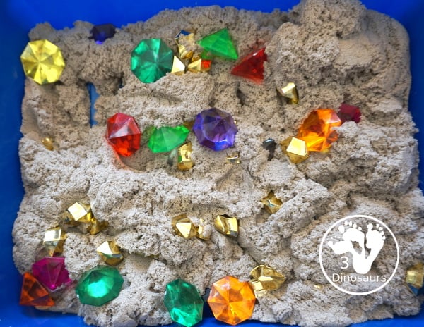 Pirate Treasure Kinetic Sensory Bin - a fun sensory bin for a pirate theme or talk like a pirate day. A fun way to dig and search and find treasure in the bin with gems, gold and kinetic sand. 3Dinosaurs.com
