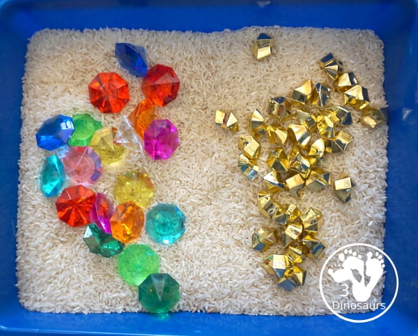 Pirate Treasure Rice Sensory Bin - a run sensory bin with gold rocks and colored gems with a rice filler for a Pirate theme that is great for Talk Like a Pirate Day or a summer pirate theme. - 3Dinosaurs.com
