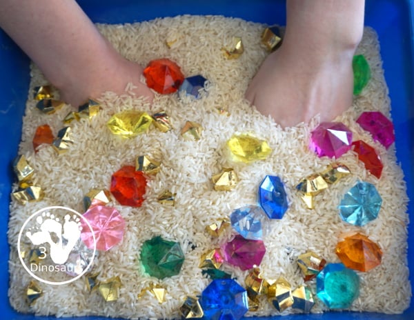 Pirate Treasure Rice Sensory Bin - a run sensory bin with gold rocks and colored gems with a rice filler for a Pirate theme that is great for Talk Like a Pirate Day or a summer pirate theme. - 3Dinosaurs.com