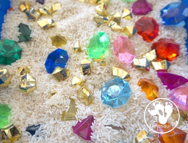 Pirate Treasure Rice Sensory Bin - a run sensory bin with gold rocks and colored gems with a rice filler for a Pirate theme that is great for Talk Like a Pirate Day or a summer pirate theme. - 3Dinosaurs.com