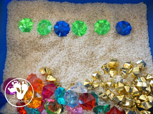Pirate Treasure Rice Sensory Bin - a run sensory bin with gold rocks and colored gems with a rice filler for a Pirate theme that is great for Talk Like a Pirate Day or a summer pirate theme. - 3Dinosaurs.com