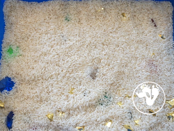 Pirate Treasure Rice Sensory Bin - a run sensory bin with gold rocks and colored gems with a rice filler for a Pirate theme that is great for Talk Like a Pirate Day or a summer pirate theme. - 3Dinosaurs.com