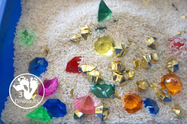 Pirate Treasure Rice Sensory Bin - a run sensory bin with gold rocks and colored gems with a rice filler for a Pirate theme that is great for Talk Like a Pirate Day or a summer pirate theme. - 3Dinosaurs.com